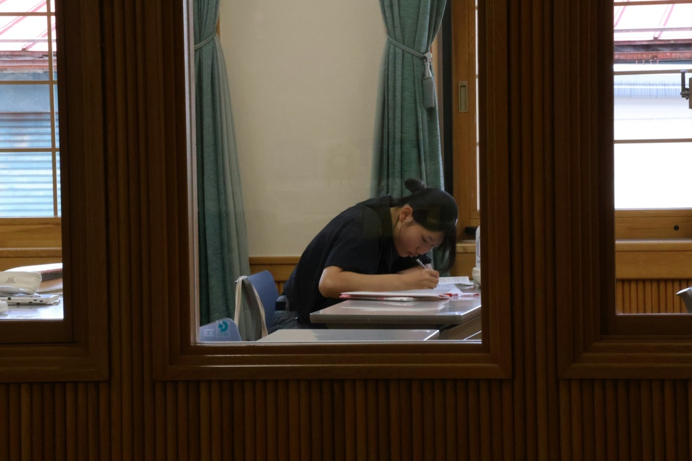 A student studying at a library desk in Japan